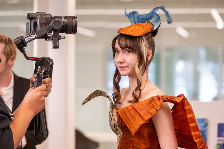 A student models one of the designs in the KSU School of Fashion biomimicry project.